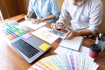 Group of young designer working in the office to design a new product, use color chart and computer laptop for new smartphone design conceptの写真素材
