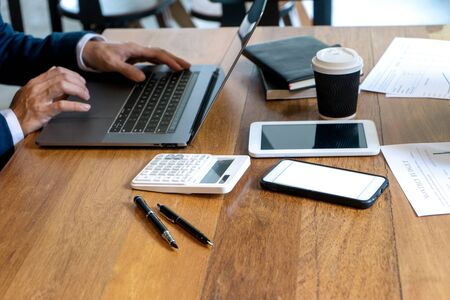 young business team in casual style have small meeting in the office talk about  analyses chart graph marketing plan with computer laptop calculator.の写真素材
