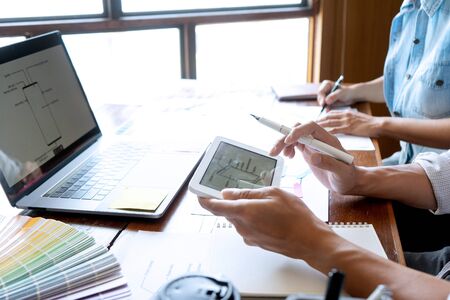 Group of young designer working in the office to design a new product, use color chart and computer laptop for new smartphone design conceptの写真素材