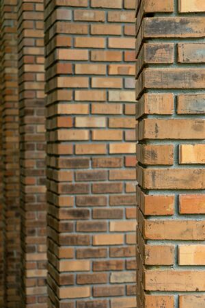 Many layer of old brick pole. Background brown orange color sepia old tone.の写真素材