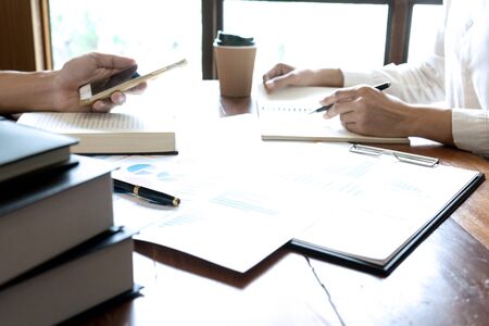 on the table business finances and accounting concept., Businessman pointing at graph and chart to...
