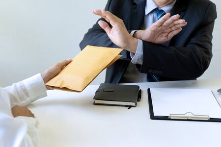 Business man give bribe to the officer but officer say no concept corruptionの写真素材