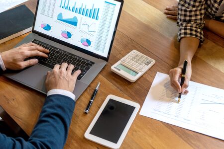young business team in casual style have small meeting in the office talk about  analyses chart graph marketing plan with computer laptop calculator.の写真素材