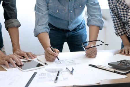 Group of engineer or architectural meeting for Construction and structure project on blueprint paper. working with partner and engineering tools on workplace. Architecture and engineering business concept.の写真素材