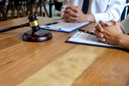 In the law firm, husband and wife signing in legal separation document, marriage law lawyer concept.の写真素材