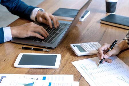 young business team in casual style have small meeting in the office talk about  analyses chart graph marketing plan with computer laptop calculator.の写真素材