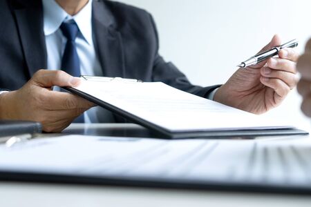 Businessman send contract business or job agreement to the new staff to sign paper.の写真素材
