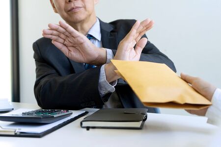 Business man give bribe to the officer but officer say no concept corruptionの写真素材
