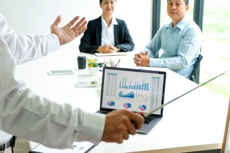 Young businessman stand in front of the group to present or business coaching to teach the technic to marketing business reach the target.の写真素材