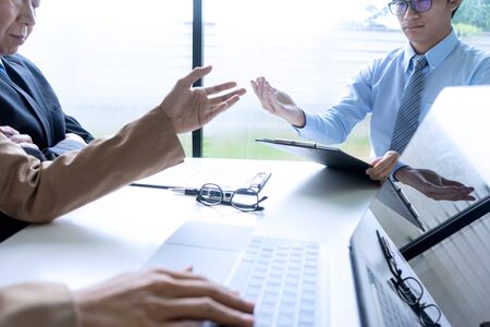 Businessman group in office, young asian people sit and speaking with resume while interviewing as candidate for job in big company. career and recruitment conceptの写真素材