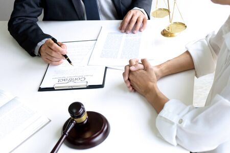 Judge or lawyer talking  with team or client about consult law detail and prepare to sign contract agreement, law firm concept.の写真素材