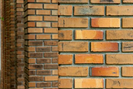 Many layer of old brick pole. Background brown orange color sepia old tone.の写真素材