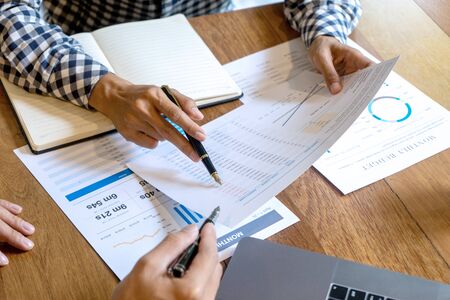 young business team in casual style have small meeting in the office talk about  analyses chart graph marketing plan with computer laptop calculator.の写真素材