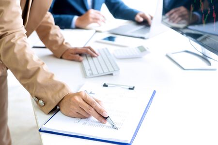 Businesswoman working with laptop for analyzing data. Key the notebook on the tableの写真素材