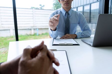 Businessman group in office, young asian people sit and speaking with resume while interviewing as candidate for job in big company. career and recruitment conceptの写真素材