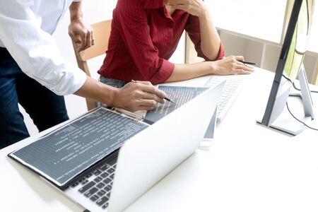 Teamwork team programmer working with computer desktop and laptop and computer code in paper print.の写真素材