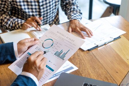 young business team in casual style have small meeting in the office talk about  analyses chart graph marketing plan with computer laptop calculator.の写真素材