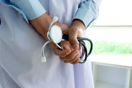 Back side of a doctor hold stethoscope in his handの写真素材