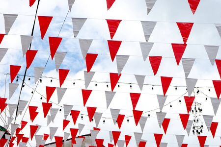 sky with many line of flag red and white decor over the street to show celebration festivalの写真素材
