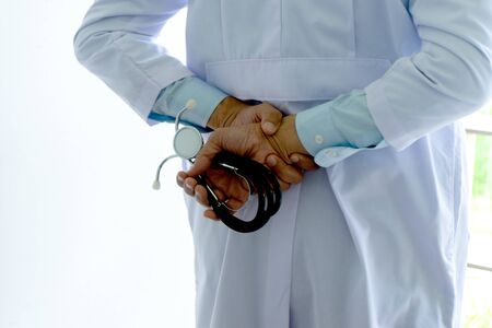 Back side of a doctor hold stethoscope in his handの写真素材