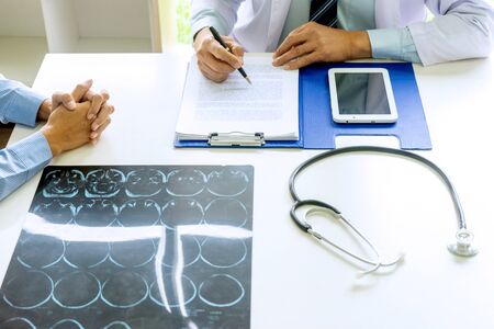 Doctor sit with patient talk consultant discuss about health care for good life.