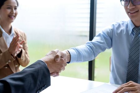 Successful business job interview, Young attractive asian employee handshaking with bossの写真素材