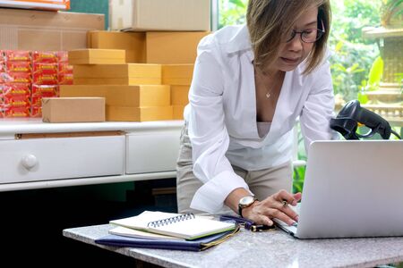 Business owner working checking order to confirm before sending customer in post office, Shipment Online Salesの写真素材