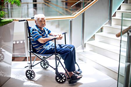 old man sit on wheelchair looking and  fill lonely in the mall waiting for take care,  dementia and alzheimerの写真素材