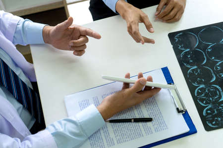 On the table in the law office business people talk about law paper, gavel and scale are on the desk.の写真素材