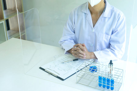 technician look to the chemical tube   In a chemical laboratoryの写真素材