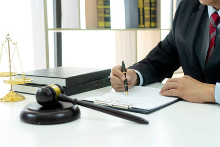 Lawyer or Judge work in the office  gavel and balance on the white table.の写真素材