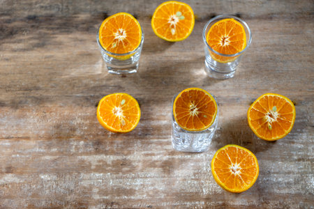 Group of oranges cut in half in   glass cup on the old wood backgroundの写真素材