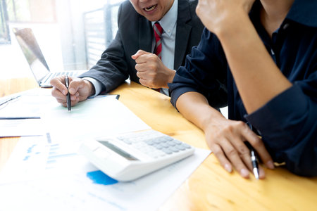 Businessman boss of the team hit the table for a force to the staff to work hard about the marketing target by use data from graph and chart to reach the targetの写真素材