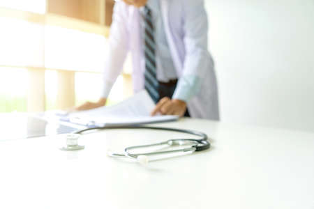 The stethoscope are on the table of professional doctor in the white clinic with more copy space.の写真素材