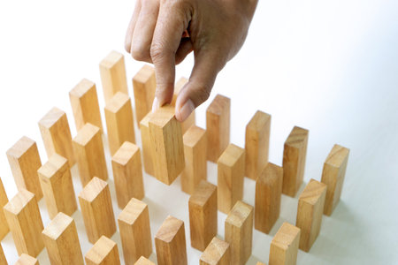 The hand take the wood block on the table for concept to the business strategy.の写真素材