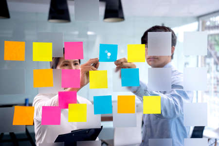 Businessmen and woman are standing He giving advice and brainstorming for Find an ideal and Write to...