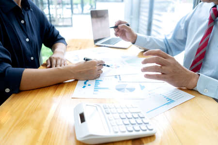 Businessmen and teamwork   look to graph chart and discussing documents on the table to discuss business planningの写真素材