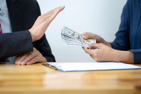 The officer refused to accept the cash money bribe  from the businessman the concept anti bribe or corruptionの写真素材