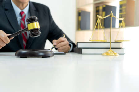 Smart businessman sitting happily thinking on a chair in the office  his hand hold the pen with more...