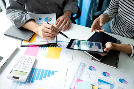 Young business woman  are explaining business plans to staff team for startup business with graph and chart in marketing plan meeting.の写真素材