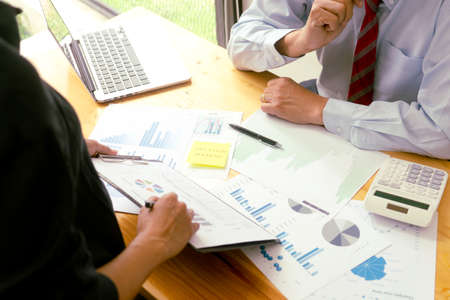 The businessperson is listening to the input from the team to make decisions on the company's marketing planning programs.の写真素材