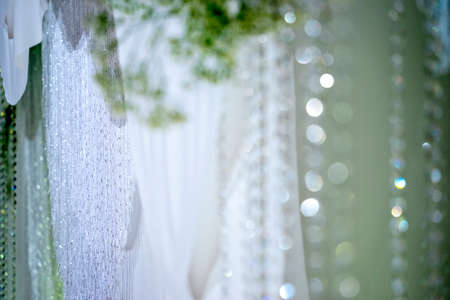 Silver pearl curtain blur abstract bokeh background with green toneの写真素材