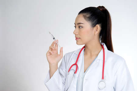 The female doctor was holding a syringe to prepare injections or Vaccine COVID-19 to patients .の写真素材