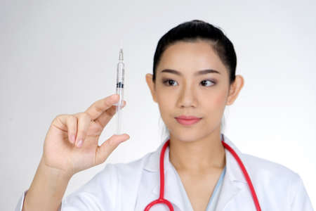 The female doctor was holding a syringe to prepare injections or Vaccine COVID-19 to patients .の写真素材