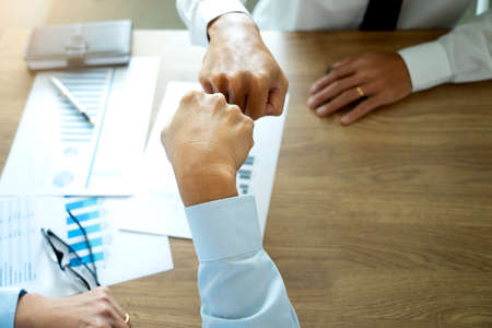 Two businessman use their hand fist bump show dealing mission business with  happy work  success teamwork top view more copy space.の写真素材