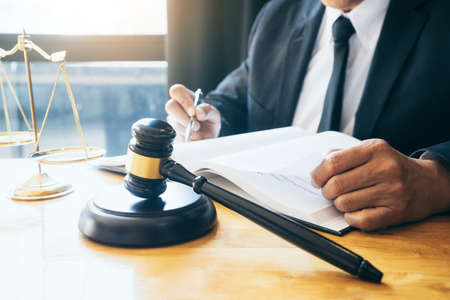 The attorneys or judge  reading legal books  in the law firm to prepare laws that will be used in legal proceedingsの写真素材