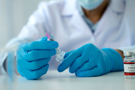 Scientists or doctor are preparing a covid-19 vaccine with syringe for the public to prevent infection bottle with the vaccine for coronavirus cure in the labÂ の写真素材
