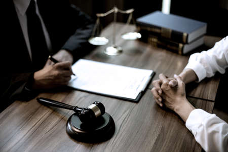 Lawyer or judge are discussion  consultation  and advice about law gavel and scales on the table in law firm sepia vintage toneの写真素材