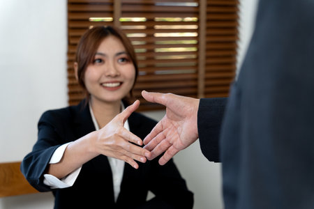young business woman are shaking hands to congratulate the success of the work with executives or customers in management planning and marketing.の写真素材