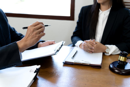 Lawyers talking to a team of women in Law firm and staff listening with interest.の写真素材